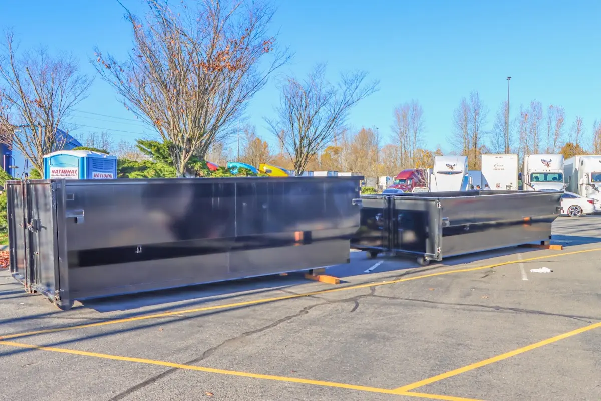 Professional dumpster rental service with roll-off container on residential driveway in Port Salerno